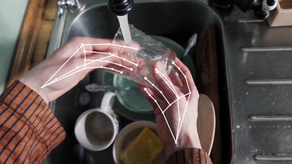 First-person view clip of washing a glass, with the engine's hand trace.
